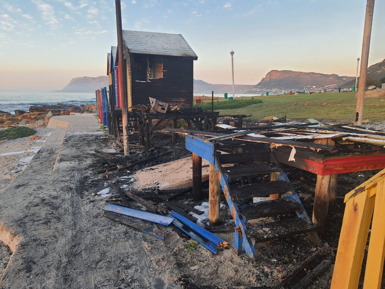 St James Beach iconic colourful bathing huts burn