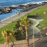 Artist spray paints mural of hope and dialogue on Sea Point promenade