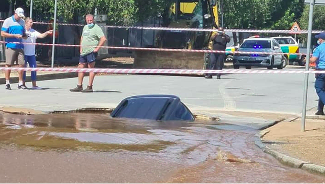 Vehicle carrying father and son plunges into a sinkhole
