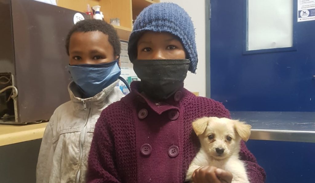 Two young girls sacrifice their last packet of chips to help puppy